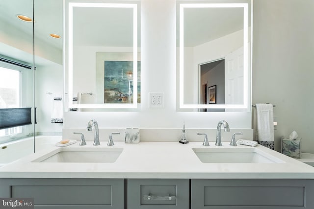 bathroom featuring double vanity and a sink