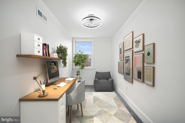 office with baseboards and visible vents