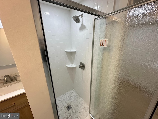 bathroom with a stall shower and vanity