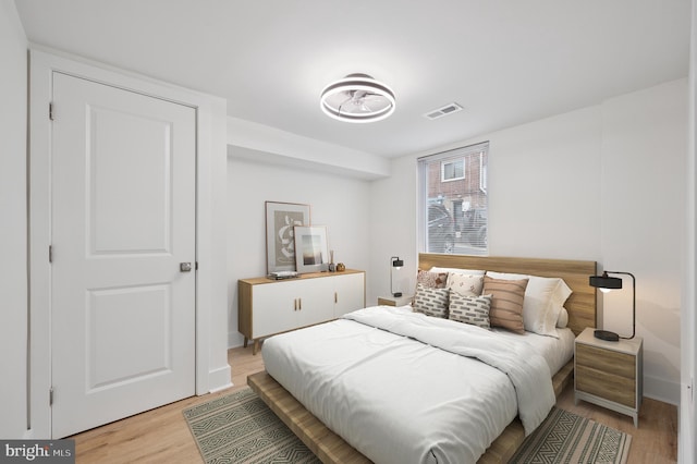 bedroom featuring visible vents and light wood-style floors