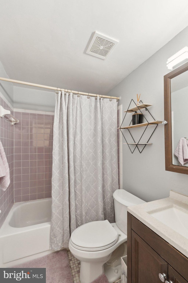 full bath with visible vents, shower / tub combo with curtain, vanity, and toilet