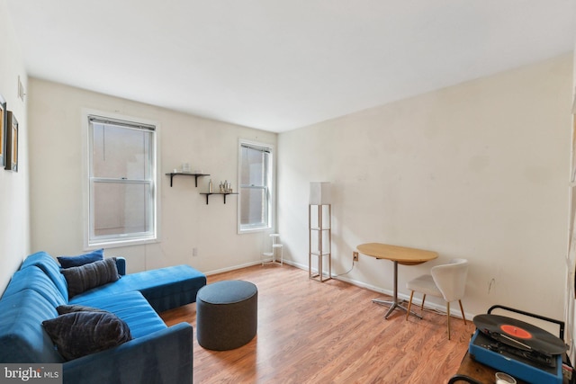 living room featuring light wood-style floors and baseboards