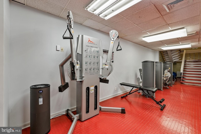 interior space with a drop ceiling, baseboards, and visible vents