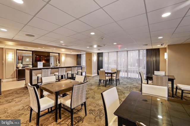 dining room featuring recessed lighting, a drop ceiling, and baseboards