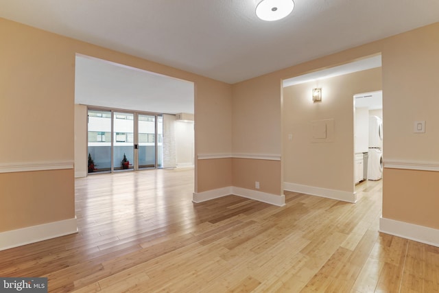 empty room featuring baseboards and light wood-style floors