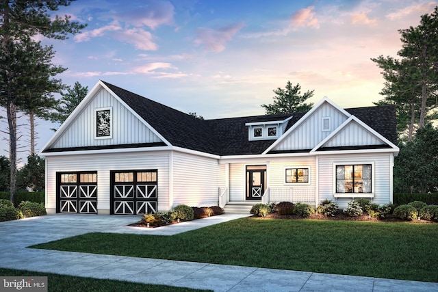 modern farmhouse style home featuring roof with shingles, a yard, an attached garage, board and batten siding, and driveway