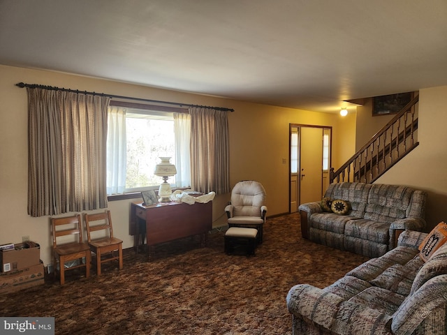 carpeted living area featuring stairway