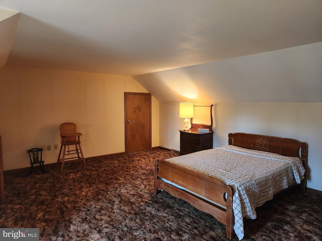 bedroom featuring carpet floors and vaulted ceiling