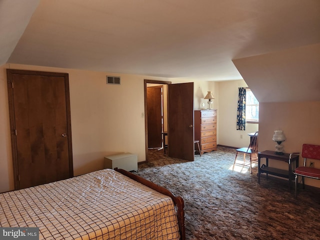 bedroom featuring carpet floors, visible vents, and vaulted ceiling