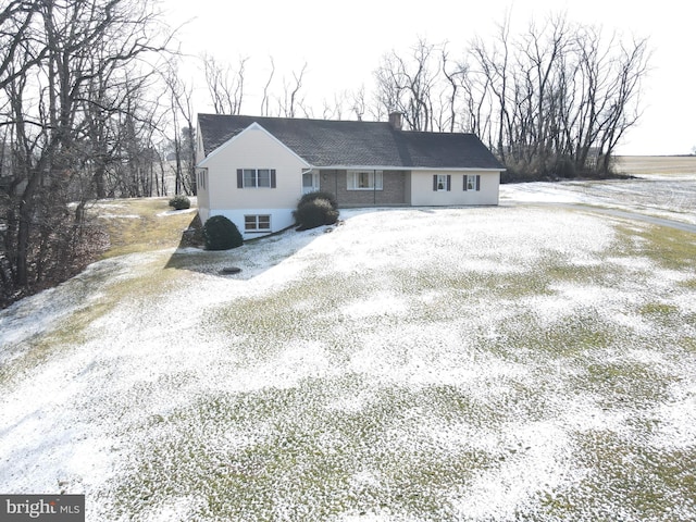 ranch-style home with driveway and a chimney