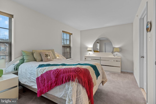 carpeted bedroom featuring baseboards