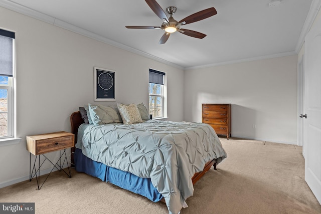 carpeted bedroom featuring ornamental molding, multiple windows, a ceiling fan, and baseboards