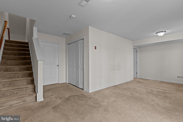 interior space with carpet, stairs, visible vents, and baseboards