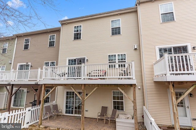 rear view of property with a patio area and fence