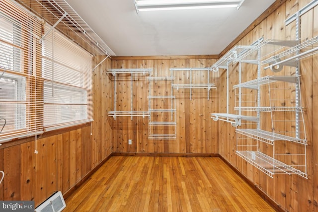 walk in closet featuring wood-type flooring and visible vents