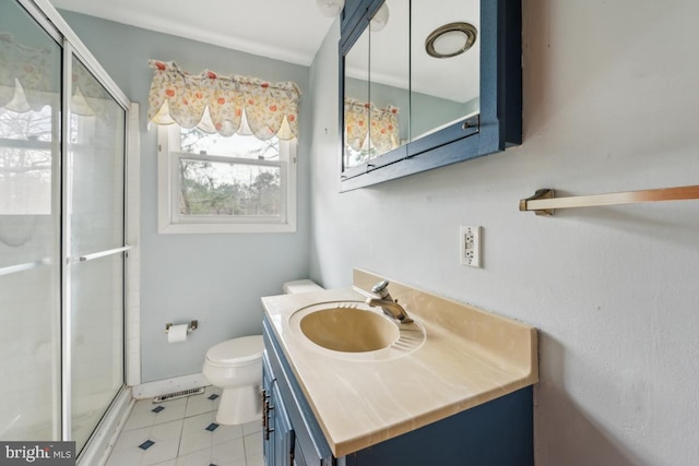 bathroom featuring toilet, tile patterned flooring, a shower stall, and vanity