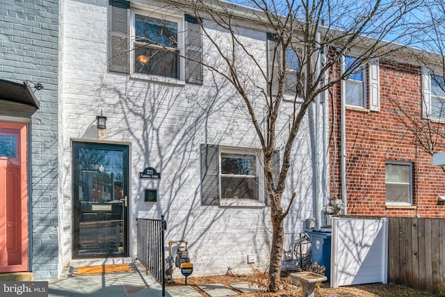 view of exterior entry featuring brick siding