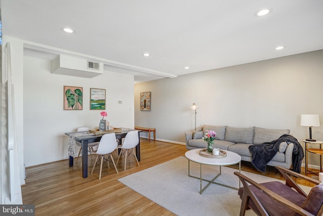 living room with recessed lighting and light wood-style flooring