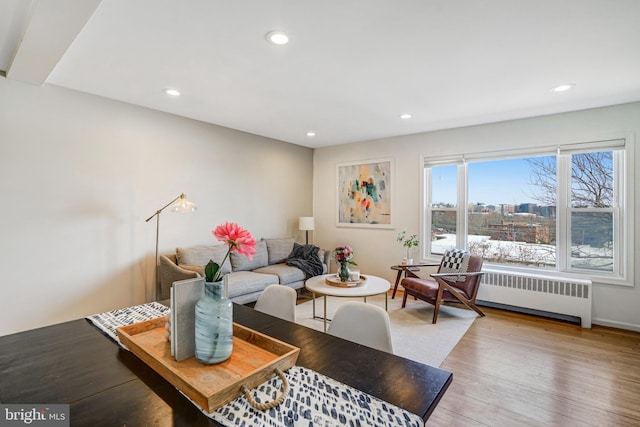 living room with recessed lighting, radiator, and light wood-style floors