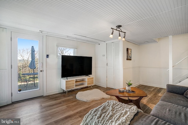 living room featuring a wainscoted wall and wood finished floors