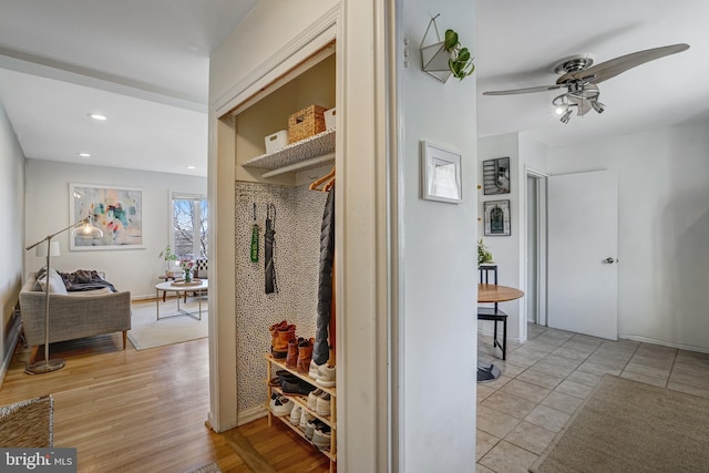 corridor with recessed lighting, baseboards, and light wood finished floors