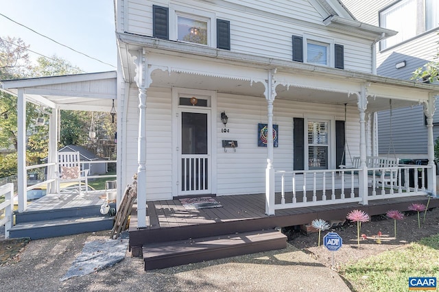 doorway to property featuring covered porch