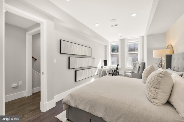 bedroom with visible vents, baseboards, wood finished floors, and recessed lighting