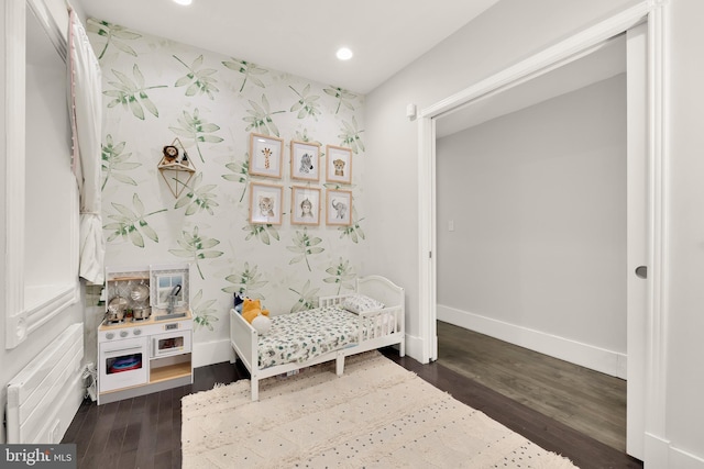 bedroom with wallpapered walls, baseboards, wood finished floors, and recessed lighting