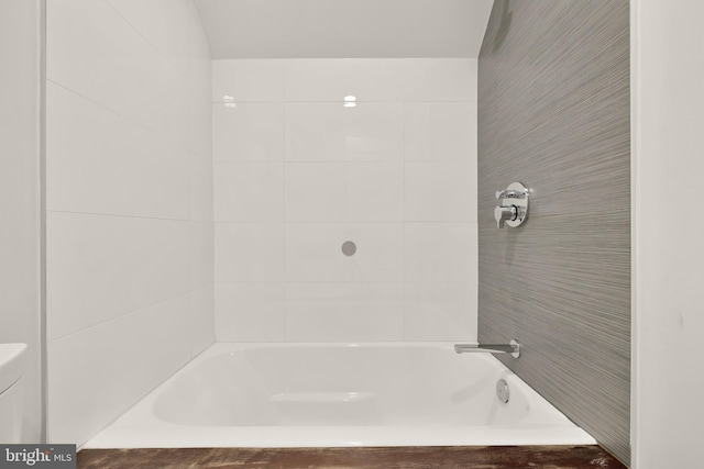 bathroom with toilet and shower / bathing tub combination