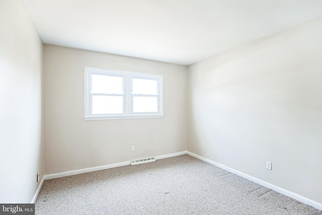 carpeted empty room with baseboards and visible vents