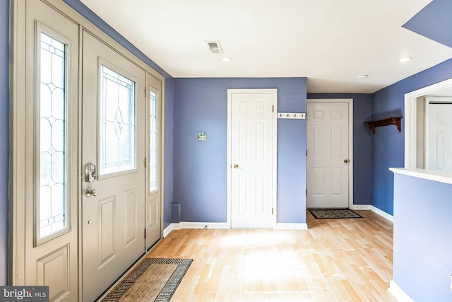 foyer with baseboards, recessed lighting, and light wood-style floors