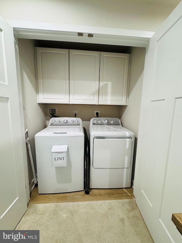 laundry room with washer and dryer and cabinet space