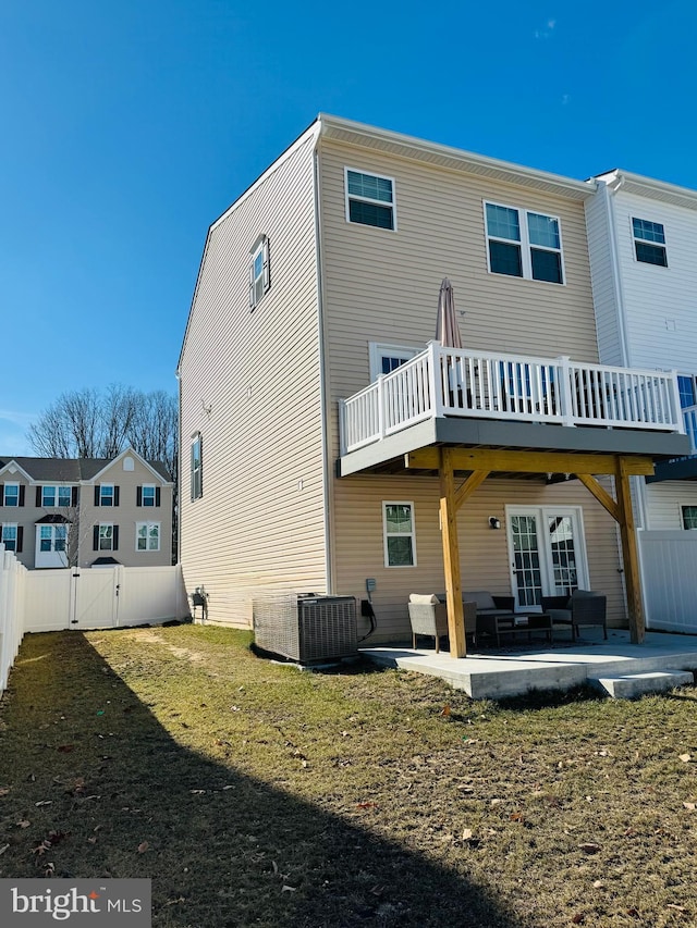 back of property with a gate, a patio, fence, and central AC unit