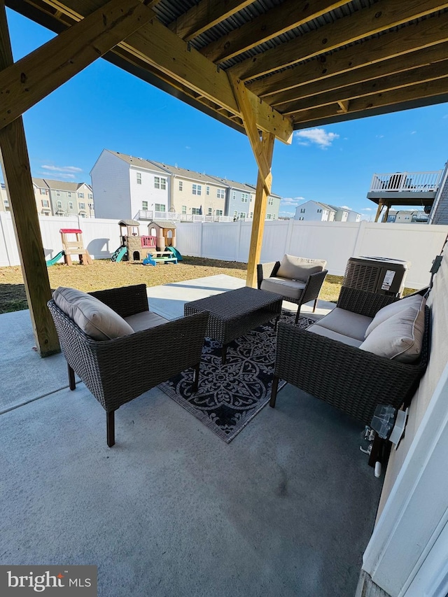 view of patio with a residential view, a playground, a fenced backyard, and an outdoor living space