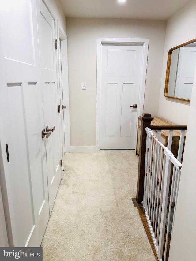 hallway with carpet and baseboards