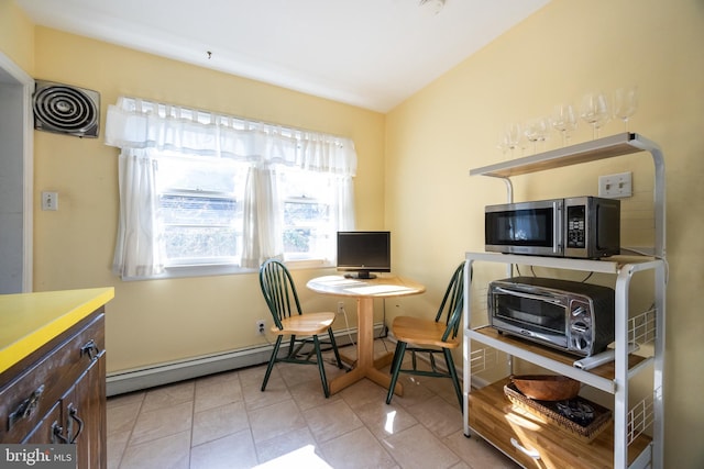 home office with a baseboard radiator, visible vents, light tile patterned flooring, and a toaster