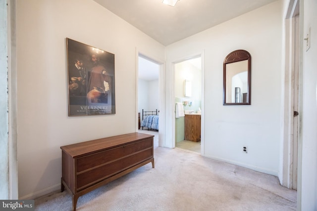 hall with baseboards and carpet