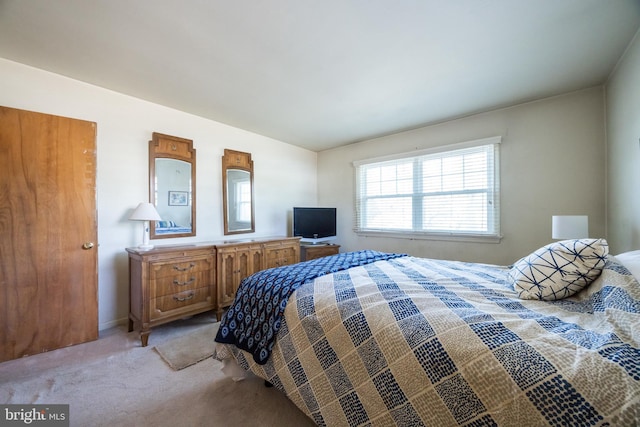 bedroom featuring light colored carpet