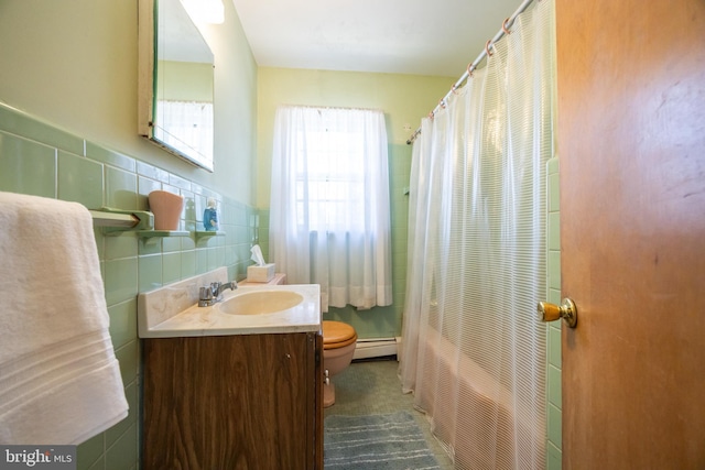 full bath with curtained shower, toilet, vanity, tile walls, and a baseboard radiator