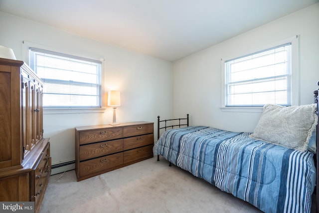 bedroom with multiple windows, light colored carpet, and a baseboard radiator