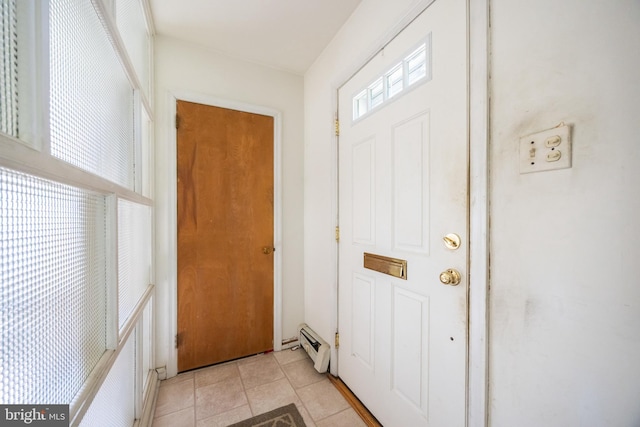 doorway to outside with light tile patterned floors