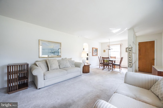 living area featuring carpet flooring and a chandelier