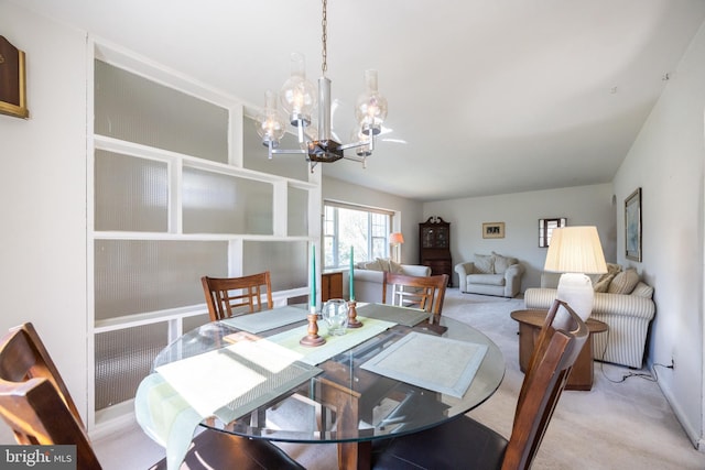 dining room with a notable chandelier and light colored carpet