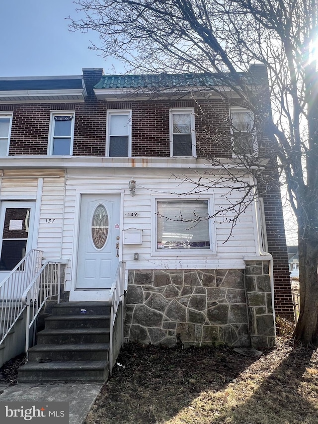 multi unit property with entry steps and brick siding