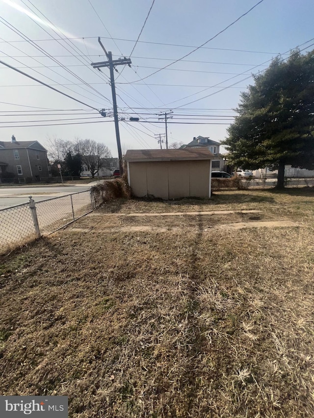 view of yard with an outbuilding and fence