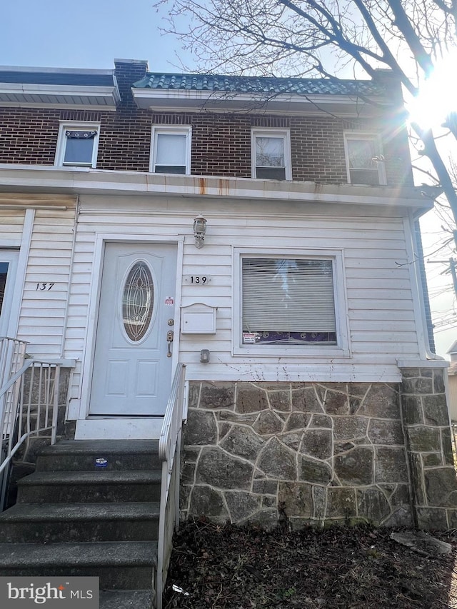 entrance to property with brick siding