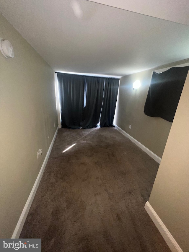 carpeted empty room with baseboards