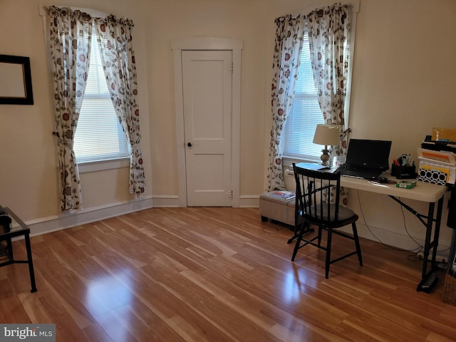 office space with wood finished floors and baseboards