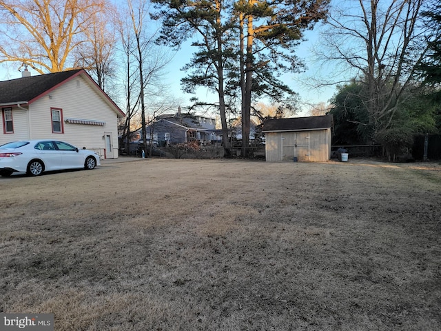 view of yard featuring a storage unit and an outbuilding