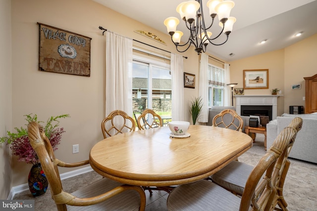 dining room with vaulted ceiling, a fireplace, baseboards, and an inviting chandelier